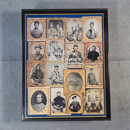 A framed historical collage print titled 'And The War Came' showing multiple vintage portrait photographs arranged in a grid with gold borders and a blue inner border, placed on a gray textured surface.