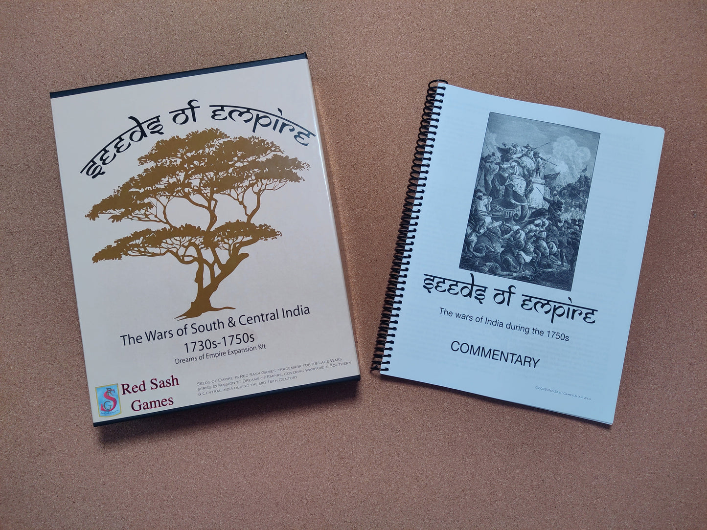 A box of 'Seeds of Empire' and its historical commentary booklet sit on a brown surface.