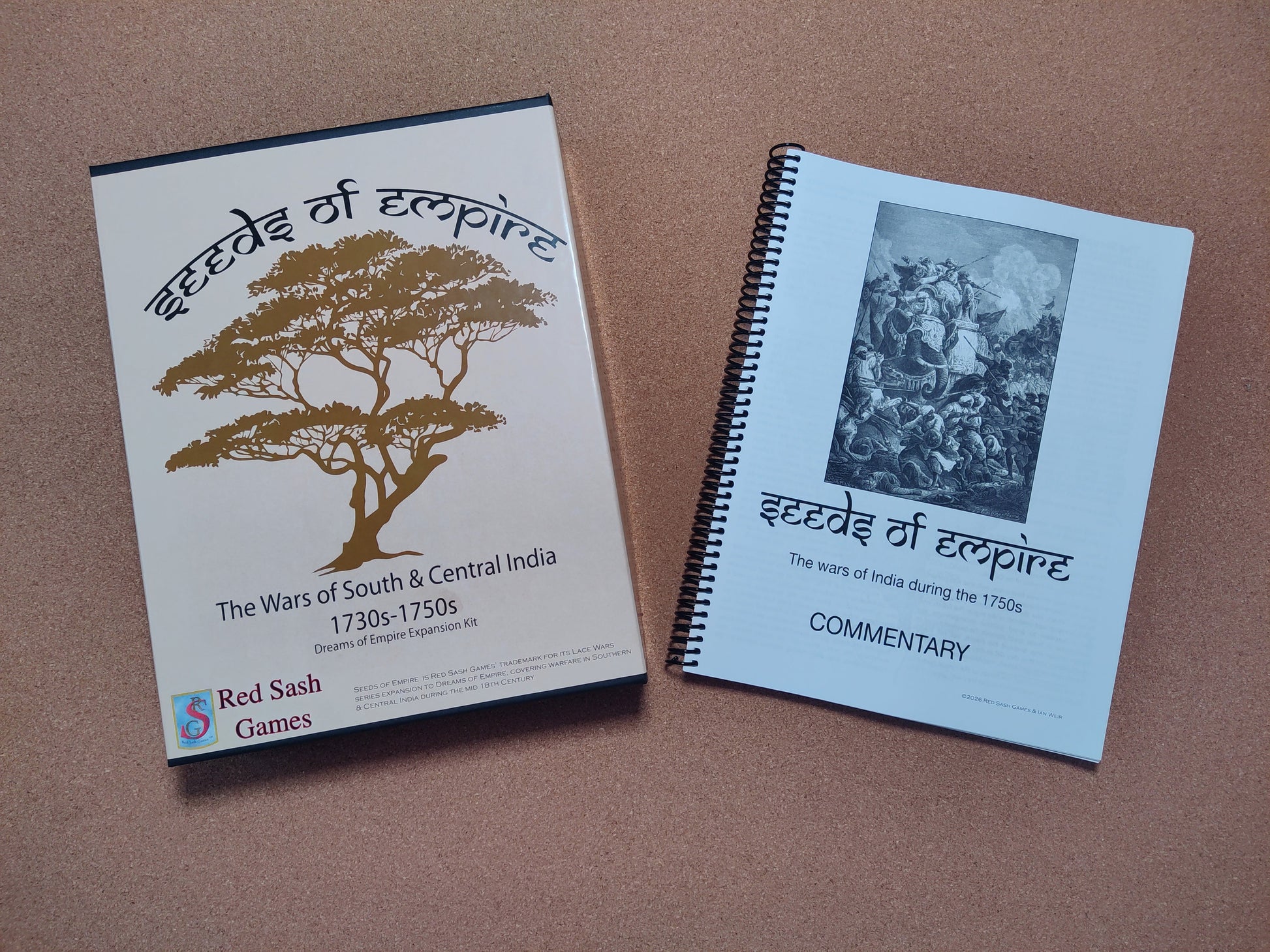 A box of 'Seeds of Empire' and its historical commentary booklet sit on a brown surface.