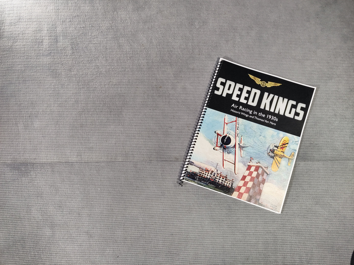 Notebook titled 'Speed Kings' on a textured gray surface